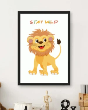 Cartoon illustration of a cheerful baby lion cub with the colorful text Stay Wild, displayed in a black nursery wall frame.